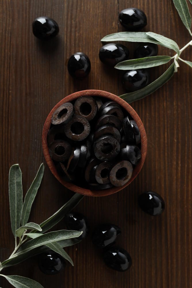 olives bowl wooden background top view